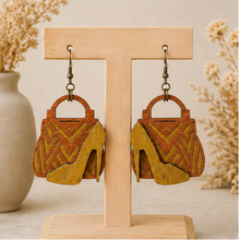 Cargar imagen en el visor de la galería, Bag & Heels 3D wooden earrings displayed front-facing on a light wood stand.
