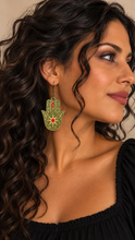 Cargar imagen en el visor de la galería, Model wearing Mystical Hamsa Hand lightweight wooden earrings with a black top