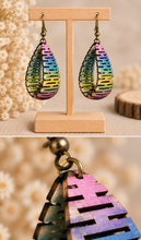 Cargar imagen en el visor de la galería, Pearlescent Rainbow wooden earrings with close-up views showing the real curved construction, painted cutouts, and bronze-tone hardware