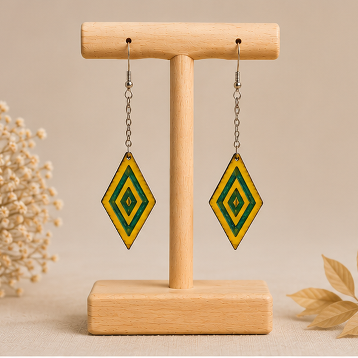 Aurora Step wooden earrings shown from the front on a light wood stand, with vivid yellow hand-painted wood, green resin accents, silver-tone chains and hooks.