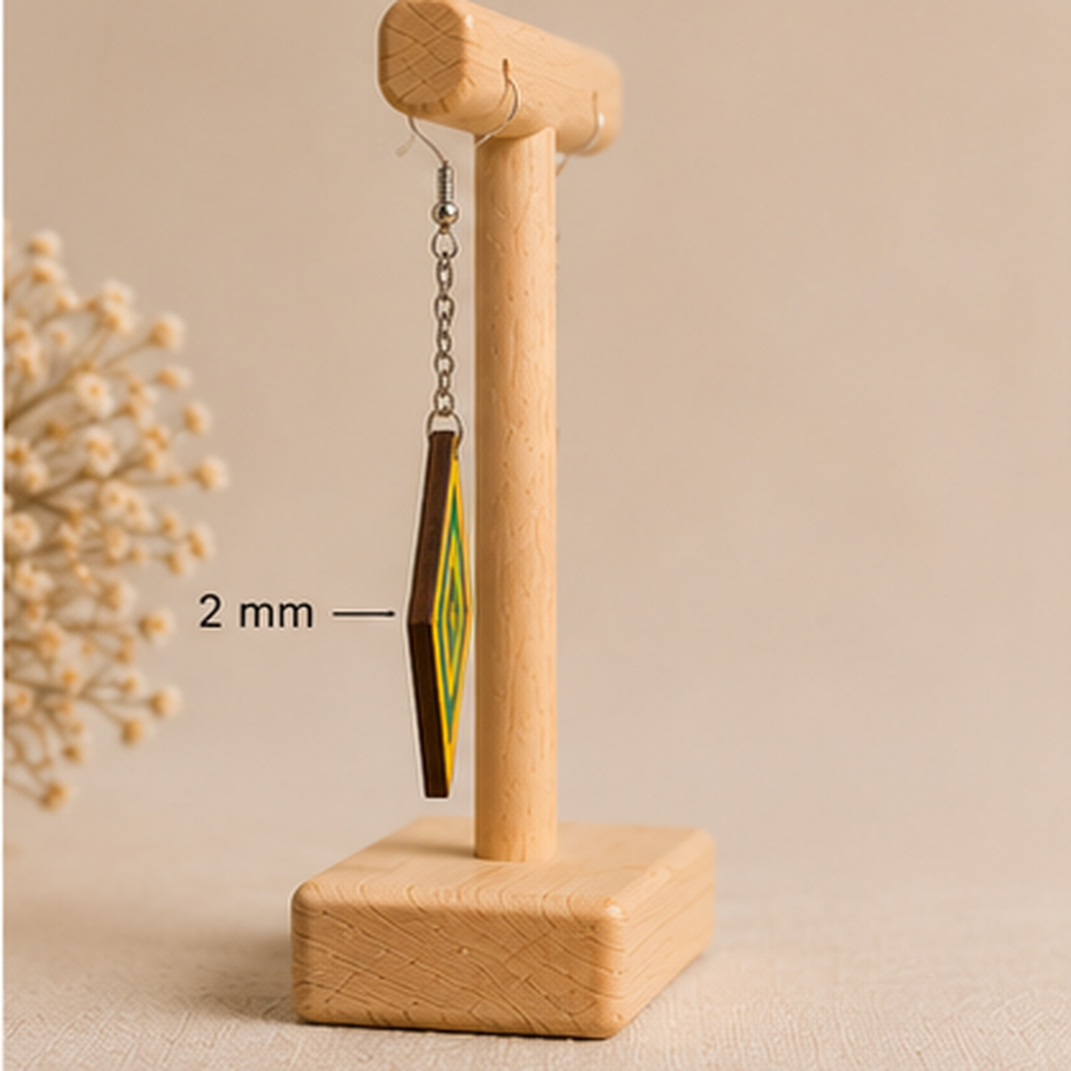 Side view of Aurora Step wooden earrings on a light wood stand, showing the 2 mm wood thickness, silver-tone chain and hook.