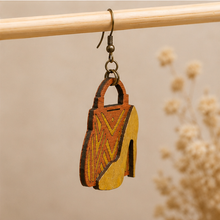 Cargar imagen en el visor de la galería, Side detail of Bag &amp; Heels 3D wooden earrings showing the layered wood construction and bronze-tone hook.
