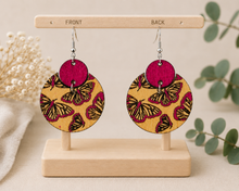 Cargar imagen en el visor de la galería, Hand-painted butterfly wooden earrings showing the same finished butterfly design on both front and back.

