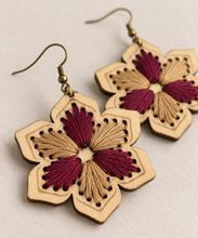 Cargar imagen en el visor de la galería, Close-up of hand embroidery and fine laser-engraved details on floral wooden earrings
