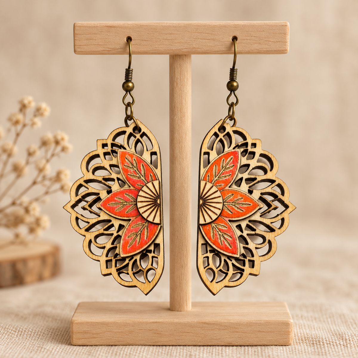 Floral Mandala wooden earrings on a light wood display stand, featuring coral hand-painted flowers, natural wood openwork, and bronze-colored hooks.