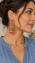 Cargar imagen en el visor de la galería, Model wearing a geometric teardrop wooden earring with a soft denim-blue top, showing the 3-inch statement earring at a natural scale.

