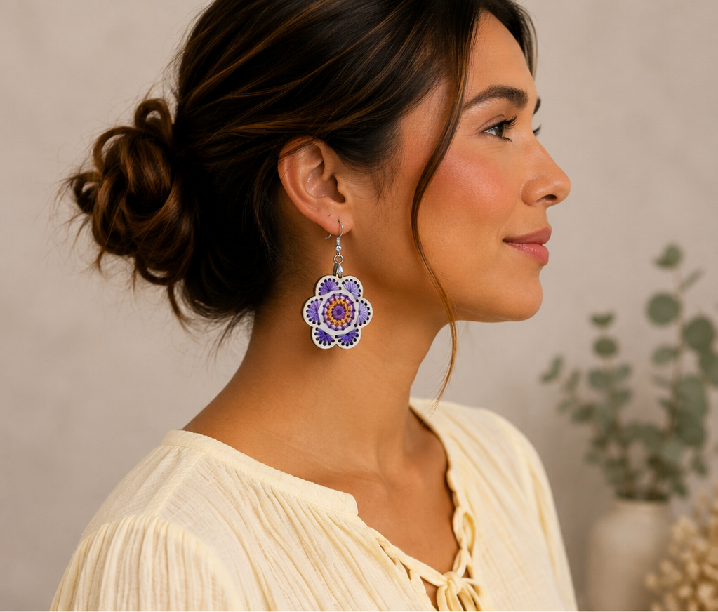 Model wearing Lavender Bloom hand-embroidered wooden earrings with a soft warm ivory blouse.