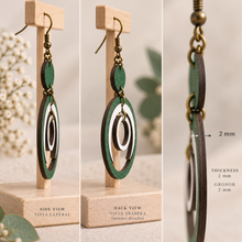 Cargar imagen en el visor de la galería, Side view of Lunar Dance articulated wooden earrings showing the 2 mm American linden wood thickness and bronze-tone hardware
