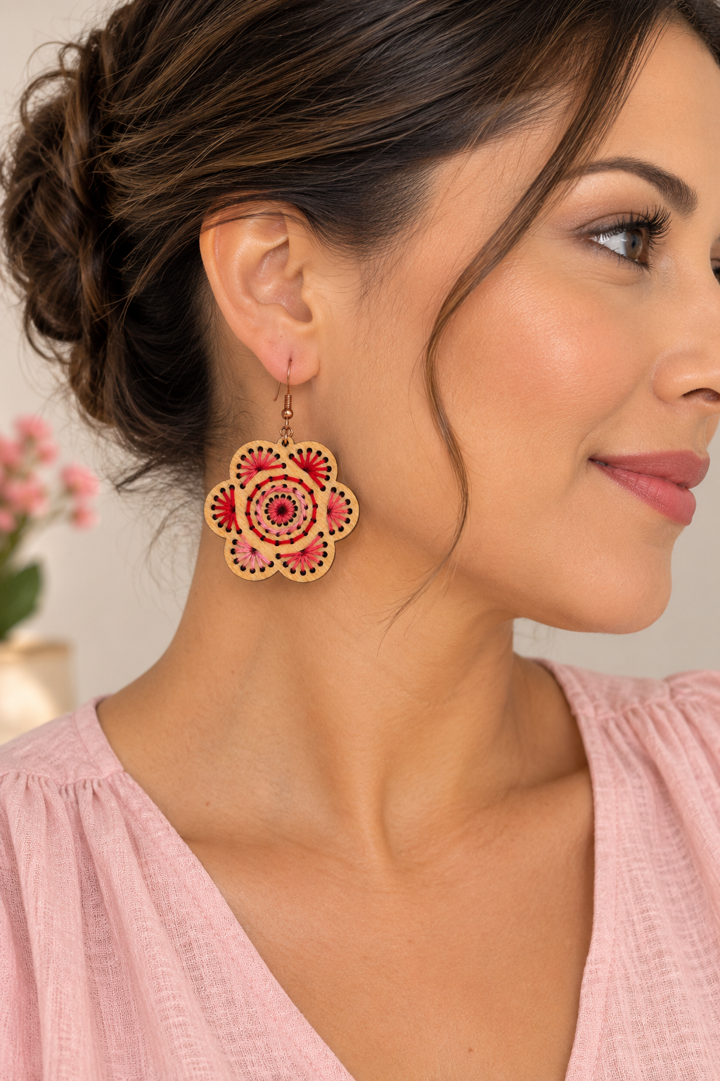 Model wearing Natural Splendor lightweight wooden flower earrings with red and pink hand embroidery and bronze-tone hooks
